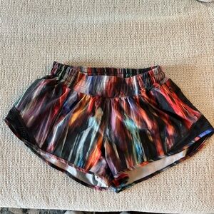 Women’s Lululemon athletic shorts: Size 4, multi color print, gently used.